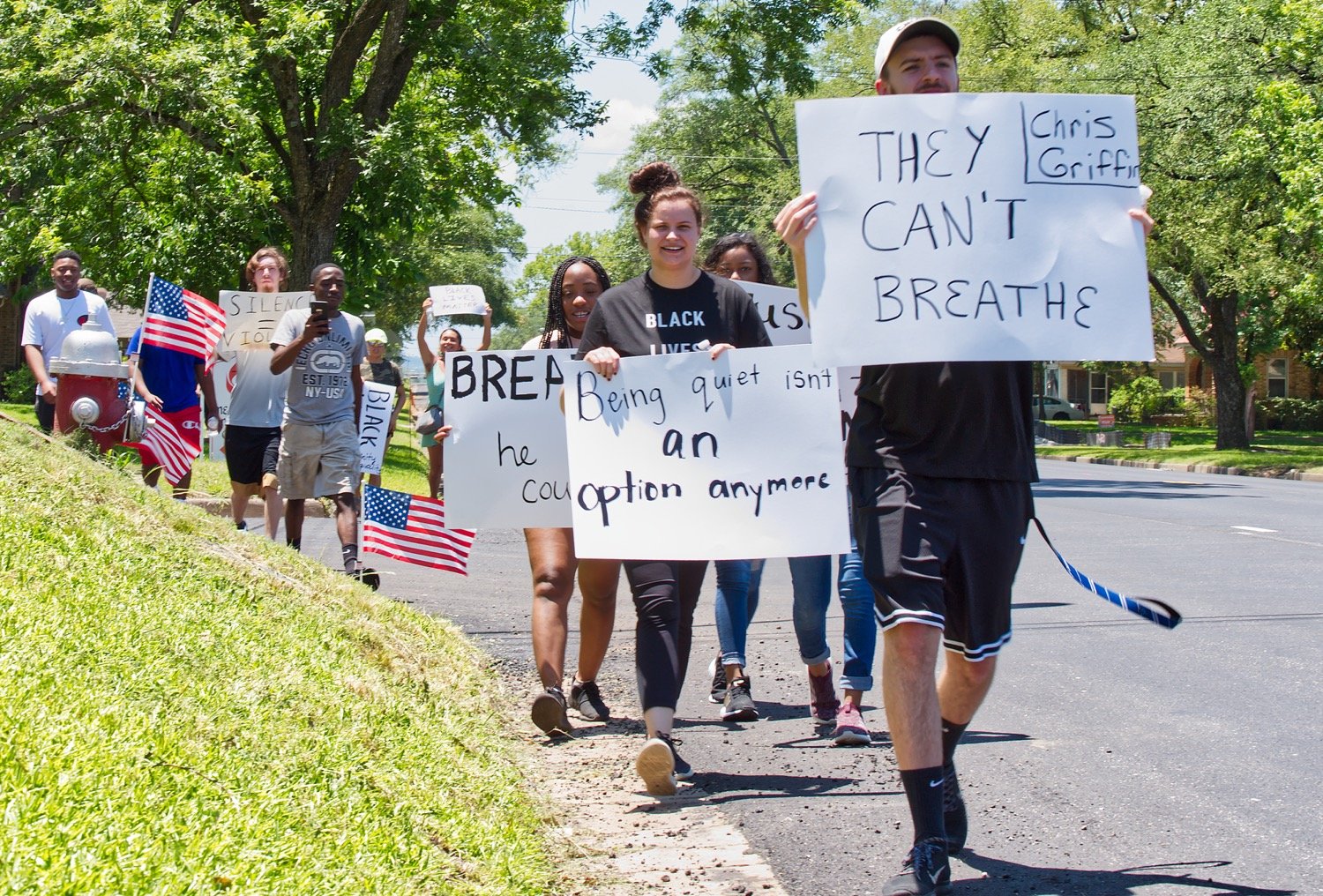 Hunter Barr leads a group of marchers through the streets of Mineola last Thursday to bring attention to oppression of black citizens. Another rally is planned Thursday at 5 p.m.